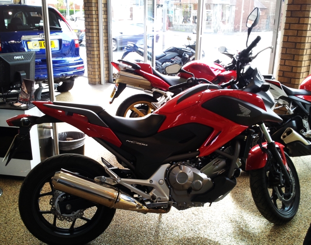 a red nc 700 x in a showroom